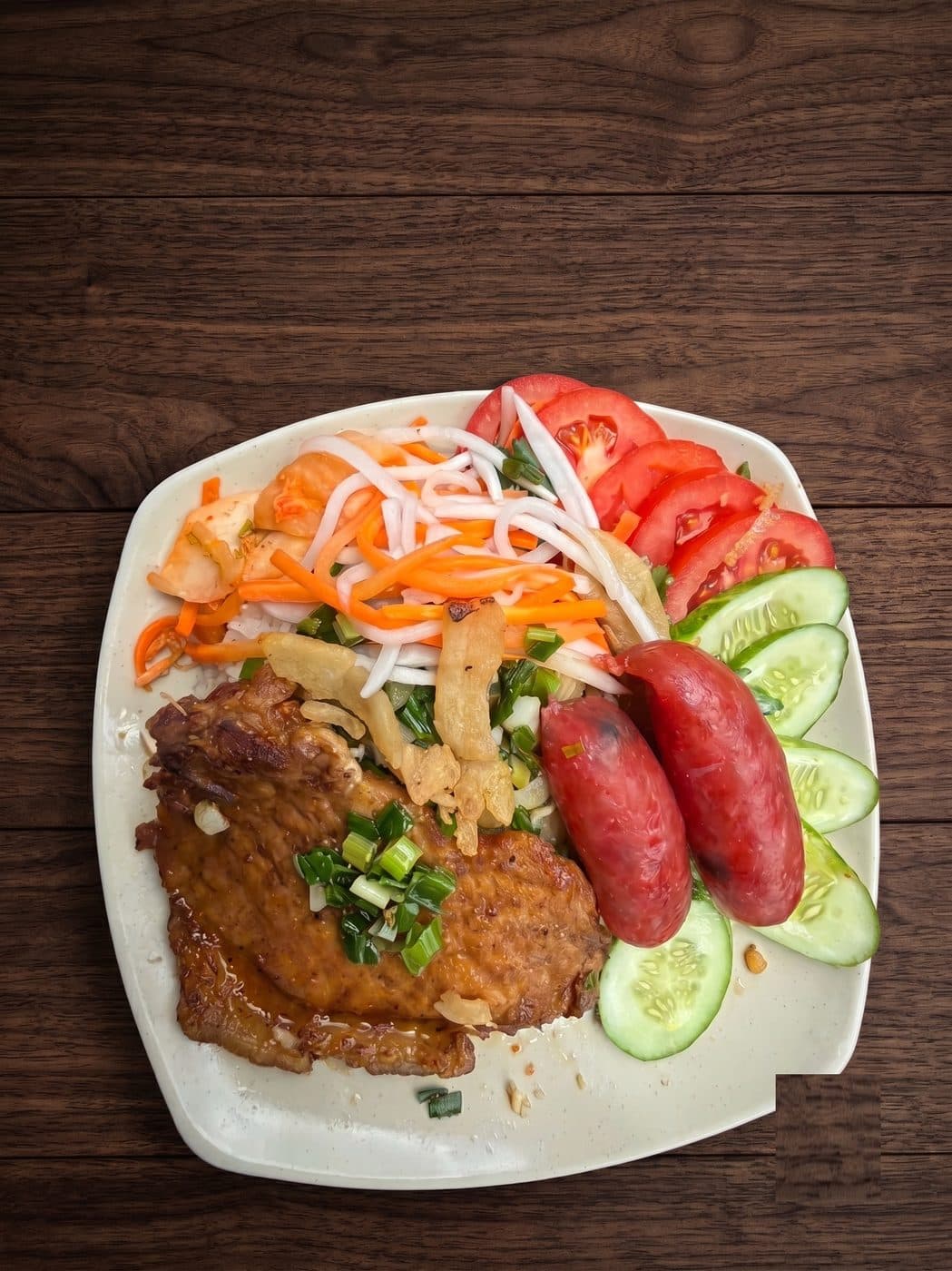 Cơm sườn lạp xưởng – Sườn nướng than hoa ăn kèm lạp xưởng chiên thơm lừng.